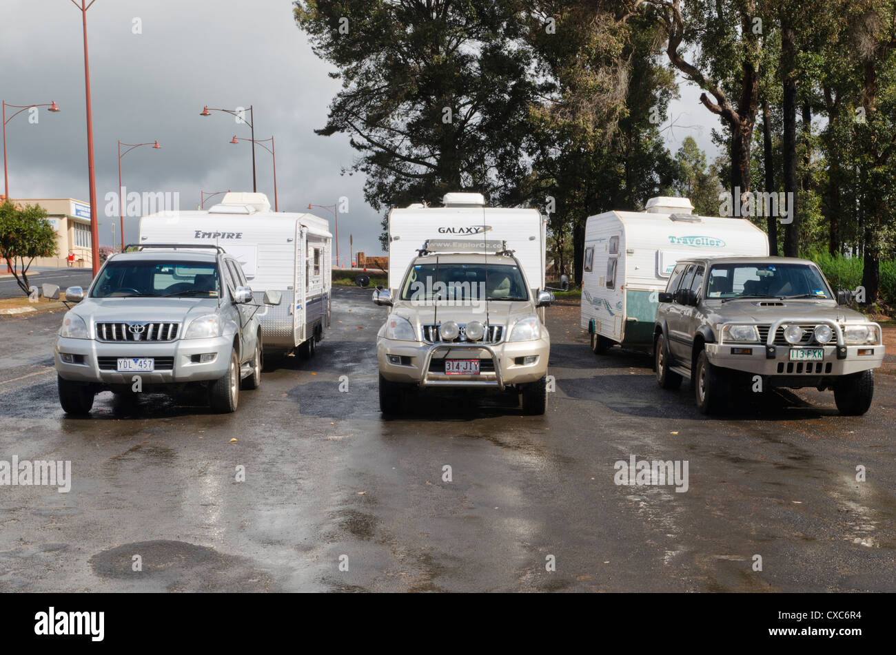 Three four-wheel drive vehicles towing caravans parked in the town of Pemberton, Western Australia Stock Photo