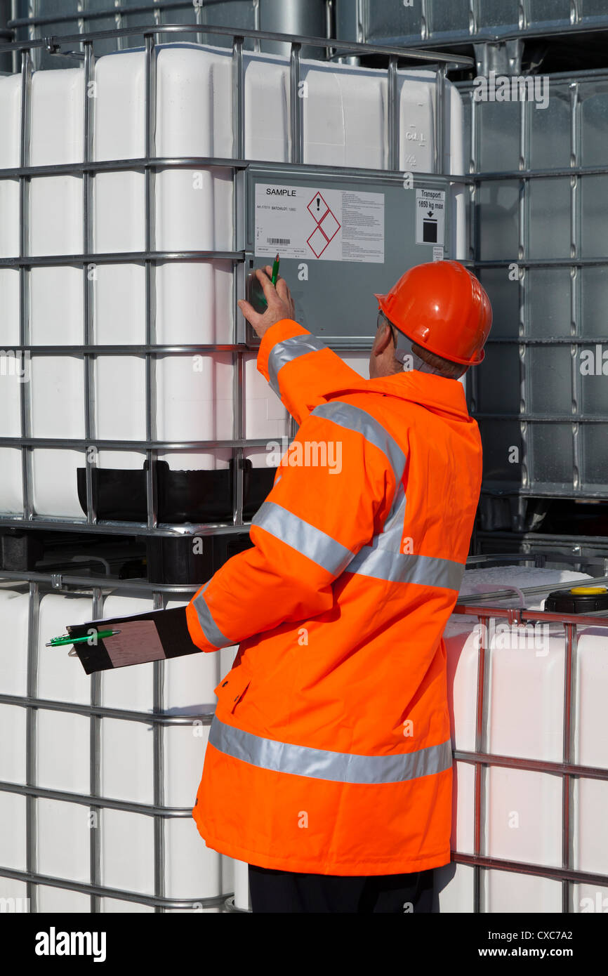 chemical plant process operator worker checking IBC