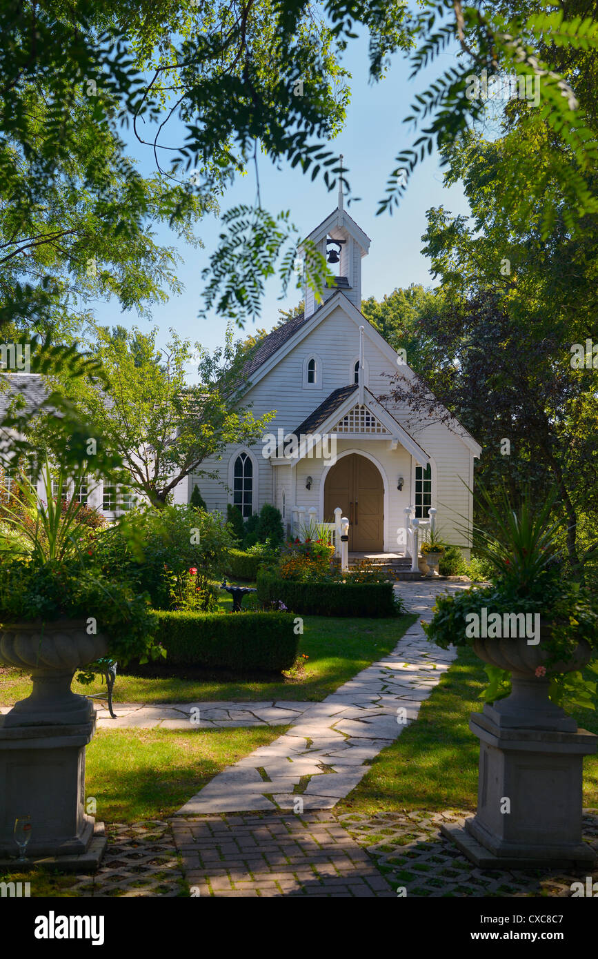 Urn planter entrance to white clapboard Chapel used for weddings in Kleinburg north of Toronto Ontario Canada Stock Photo