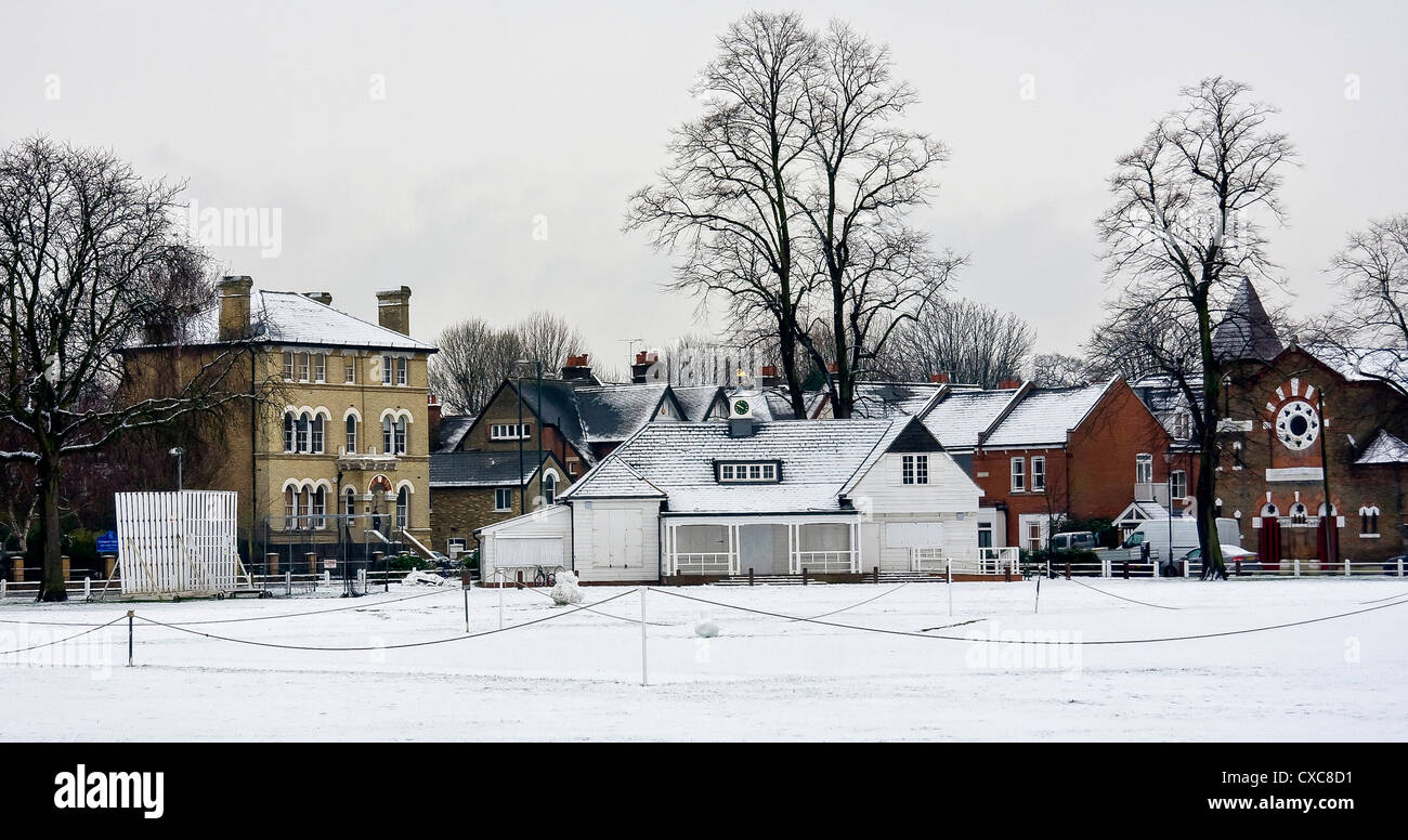 Snow covering the cricket pitch and pavilion on Twickenham Green, Greater London, UK Stock Photo