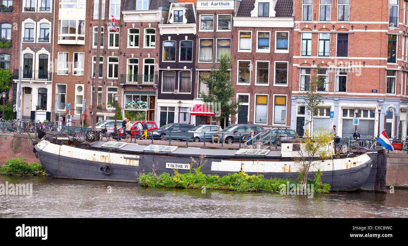 House boat at the Amstel river - Amsterdam, Netherlands, Europe Stock Photo