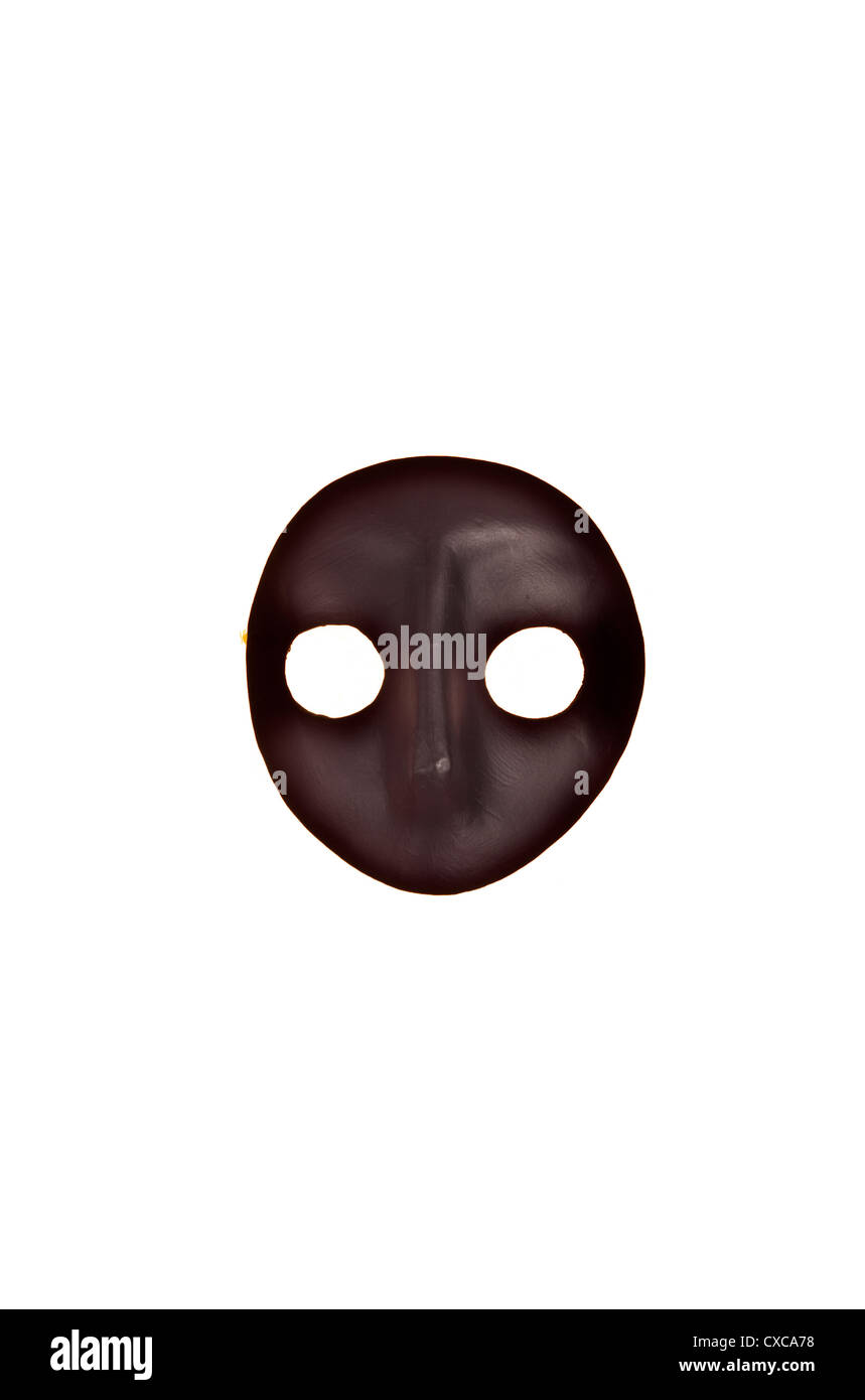 A black Venetian mask from carnival or Mardi Gras isolated against white background. Room for type. Stock Photo
