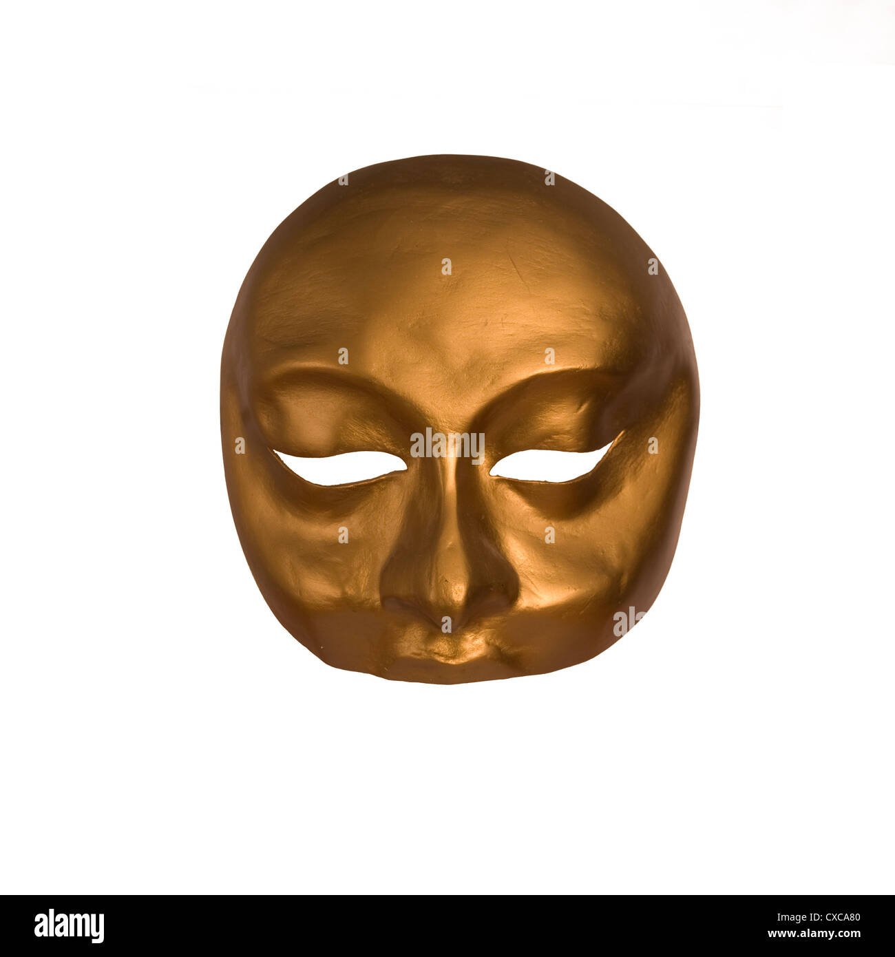 A golden Venetian mask with interesting facial expression isolated against white background. Room for type Stock Photo
