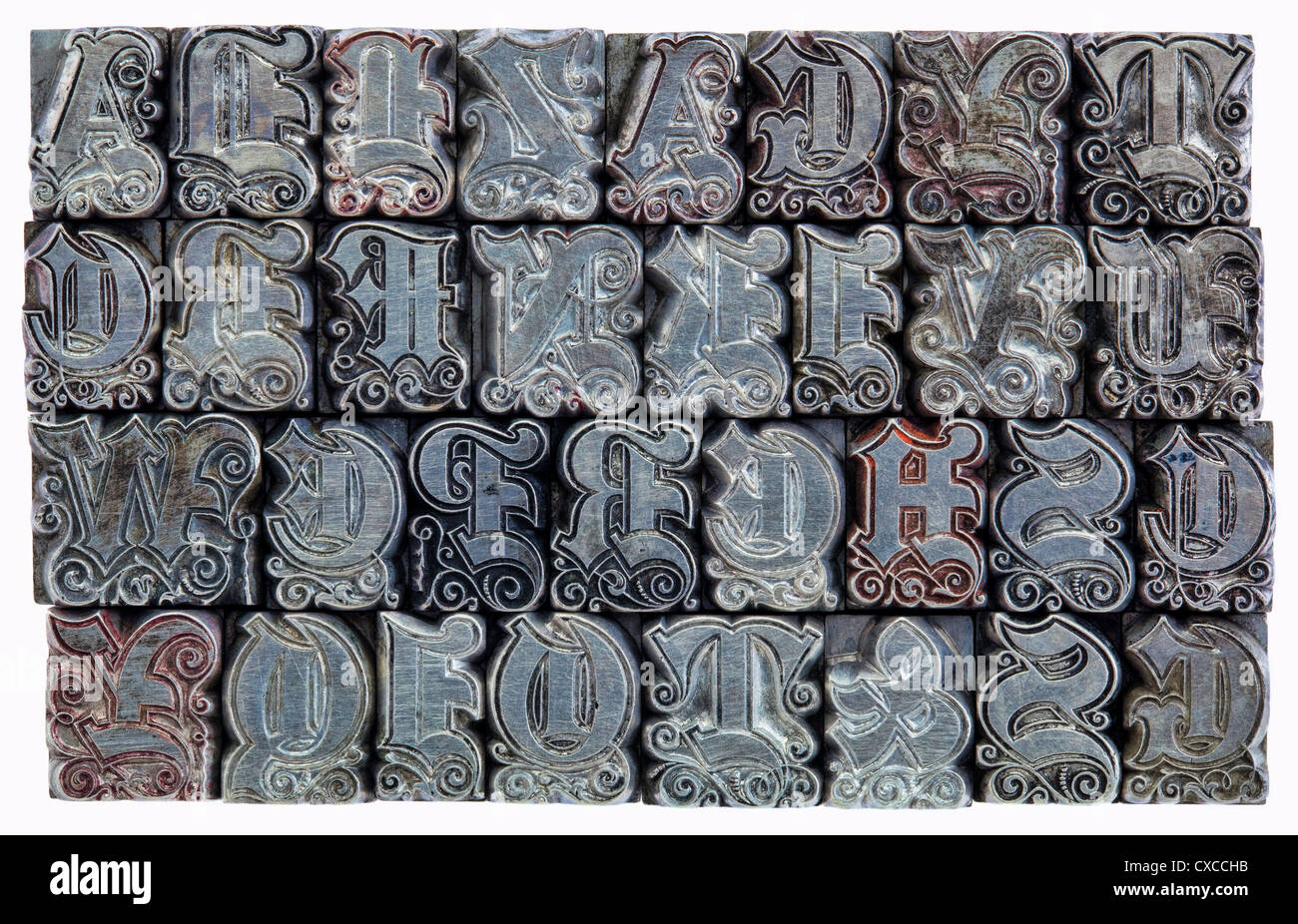 random alphabet letters in decorative metal letterpress type - initials font - stained by color inks Stock Photo