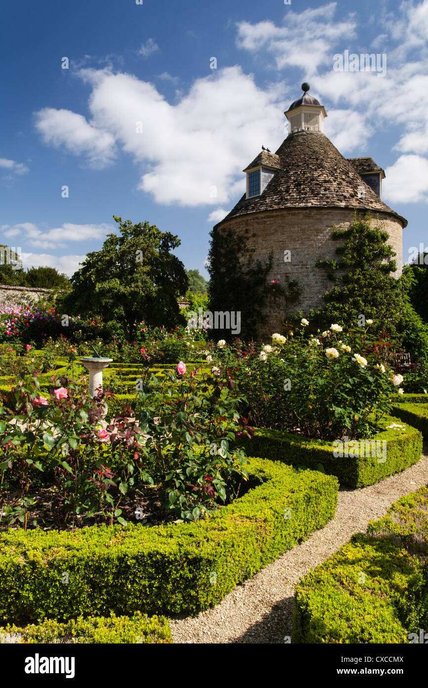 The stylish Pigeon House (c. 1685) stands amongst the Roses within the Walled Garden of Rousham House, Oxfordshire, England Stock Photo
