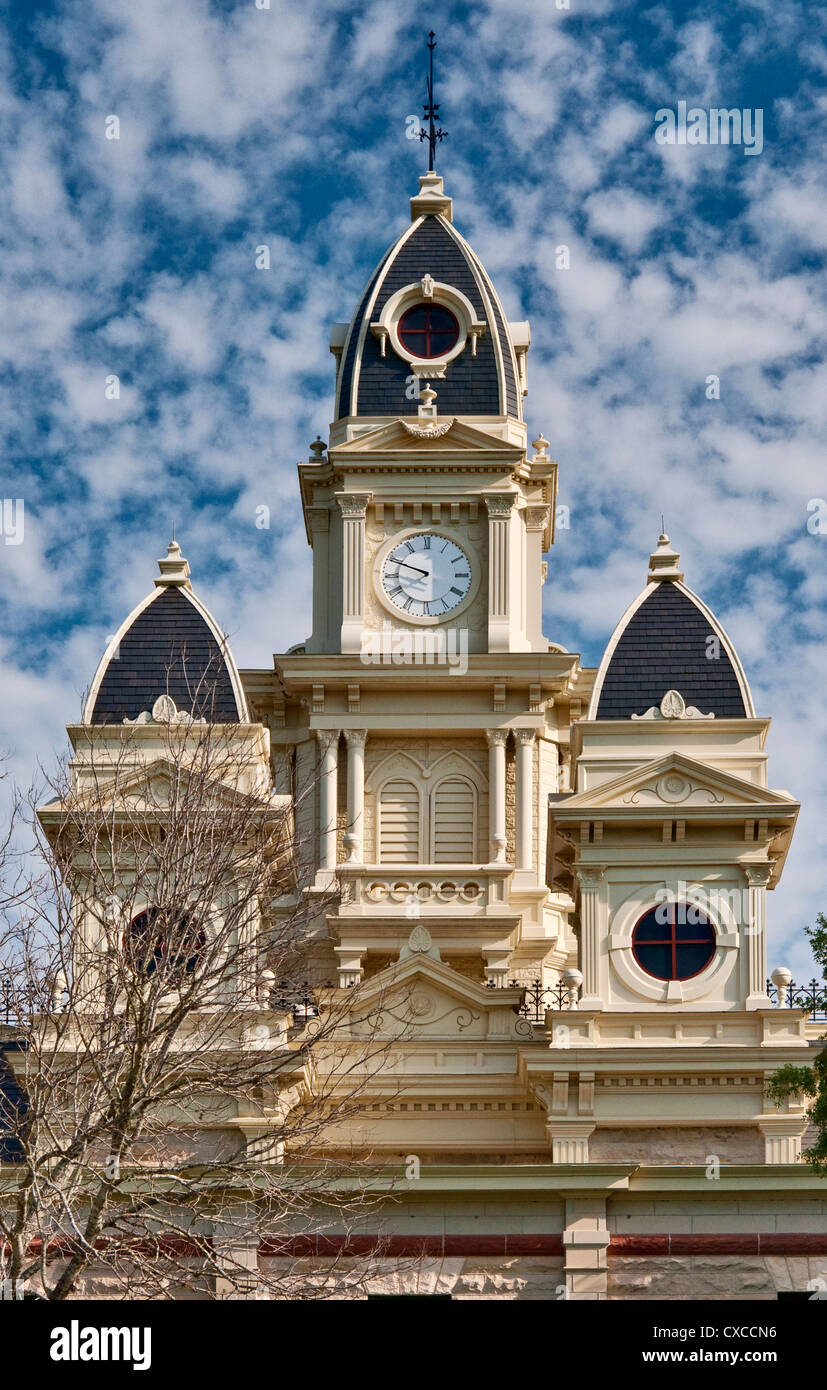 Clock tower and turrets topped with cupolas at Goliad County Courthouse (second empire/neo-gothic style), Goliad, Texas, USA Stock Photo