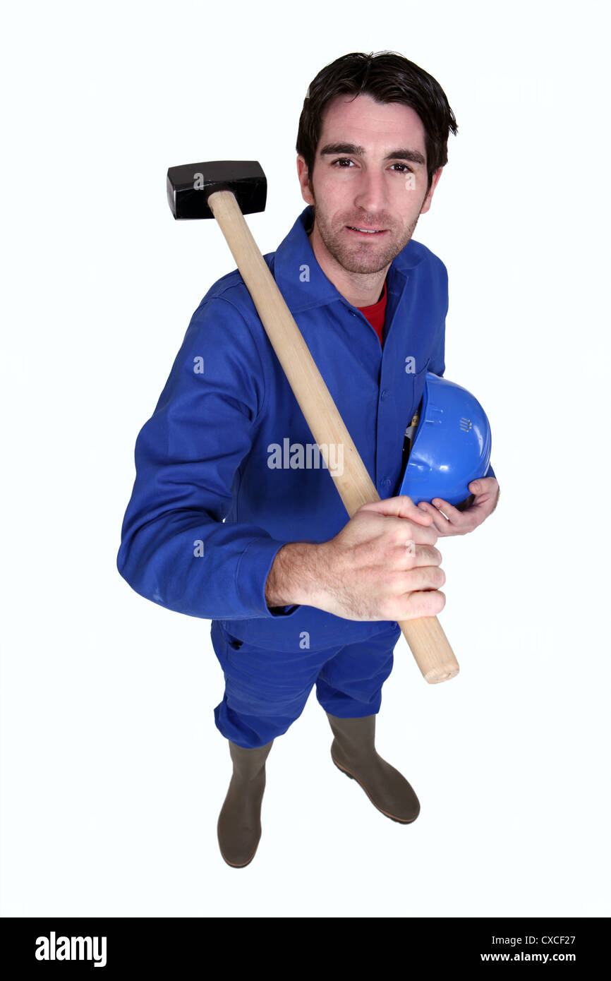 Man resting sledgehammer on shoulder Stock Photo Alamy