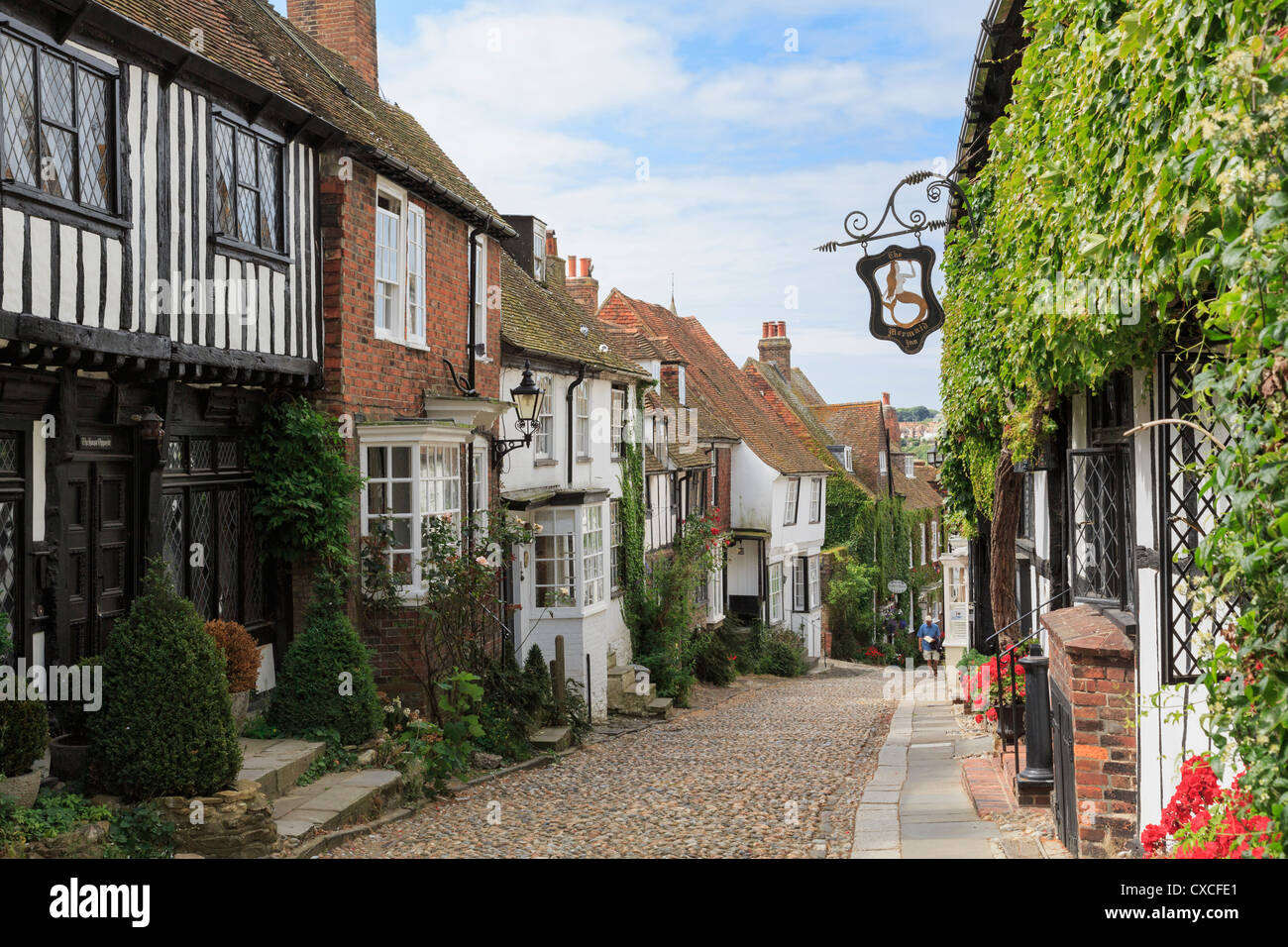 Famous narrow cobbled street with quaint old houses and haunted inn in historic Cinque Port town. Mermaid Street Rye East Sussex England UK Britain Stock Photo