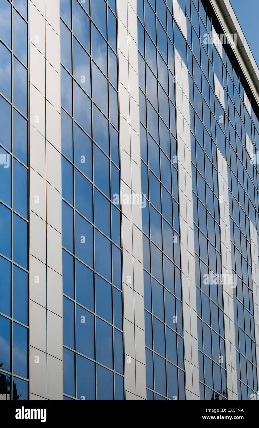 Blue sky reflected in the windows of office building Stock Photo - Alamy