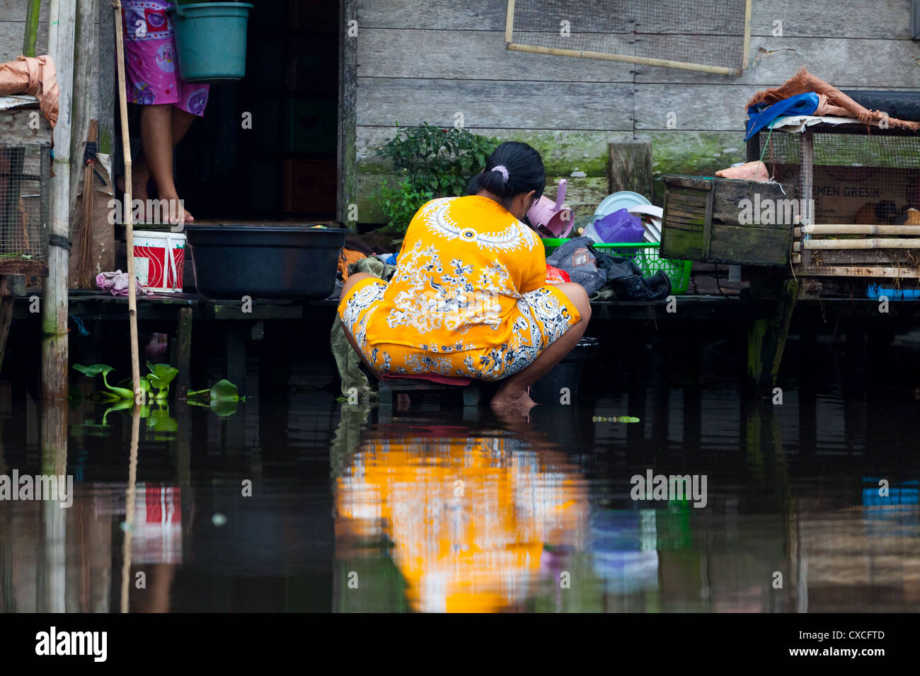 Woman working at a Canal in Banjarmasin Stock Photo