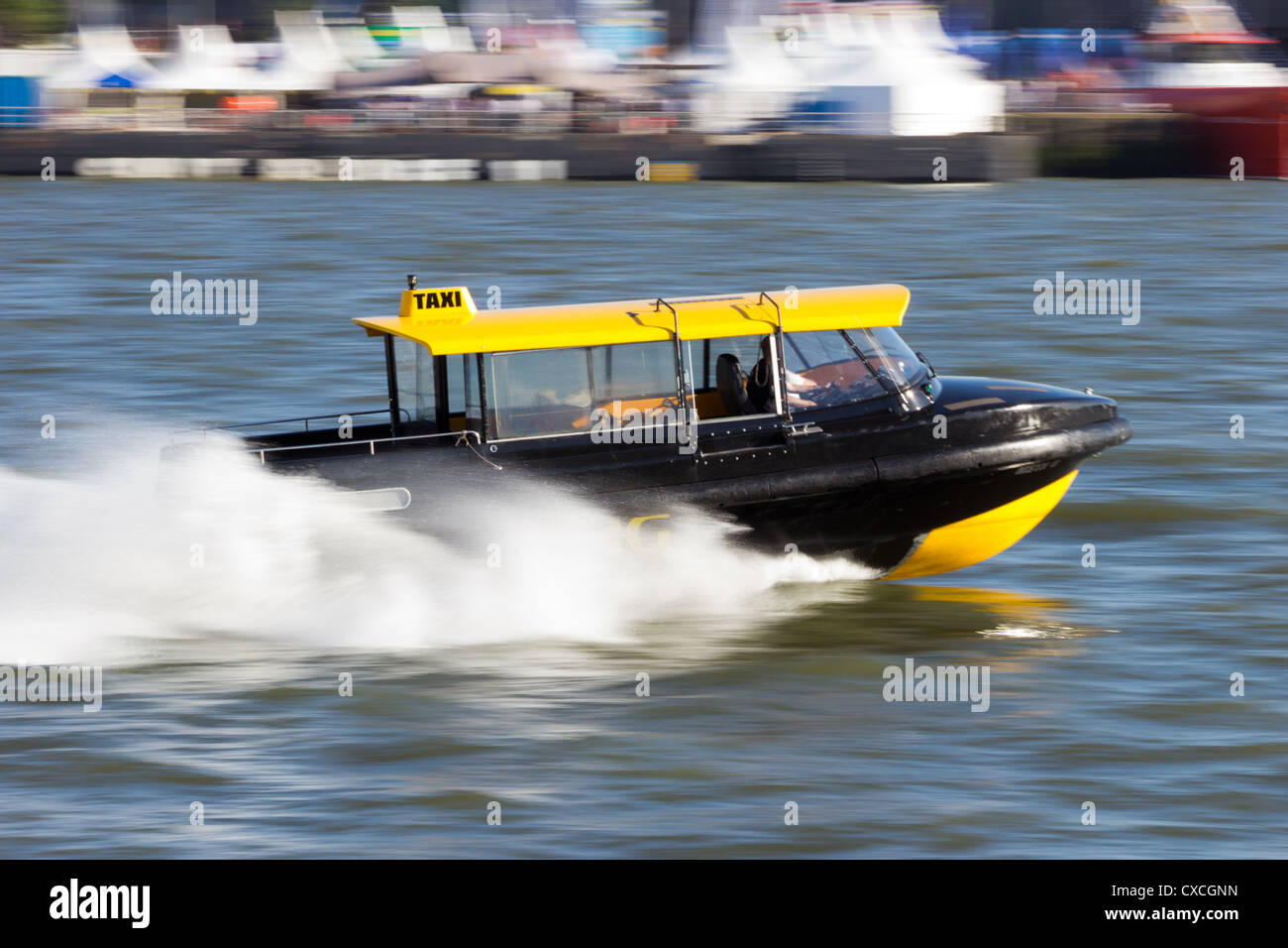 Water taxi speeding over the Meiuse river in Rotterdam, The Netherlands Stock Photo