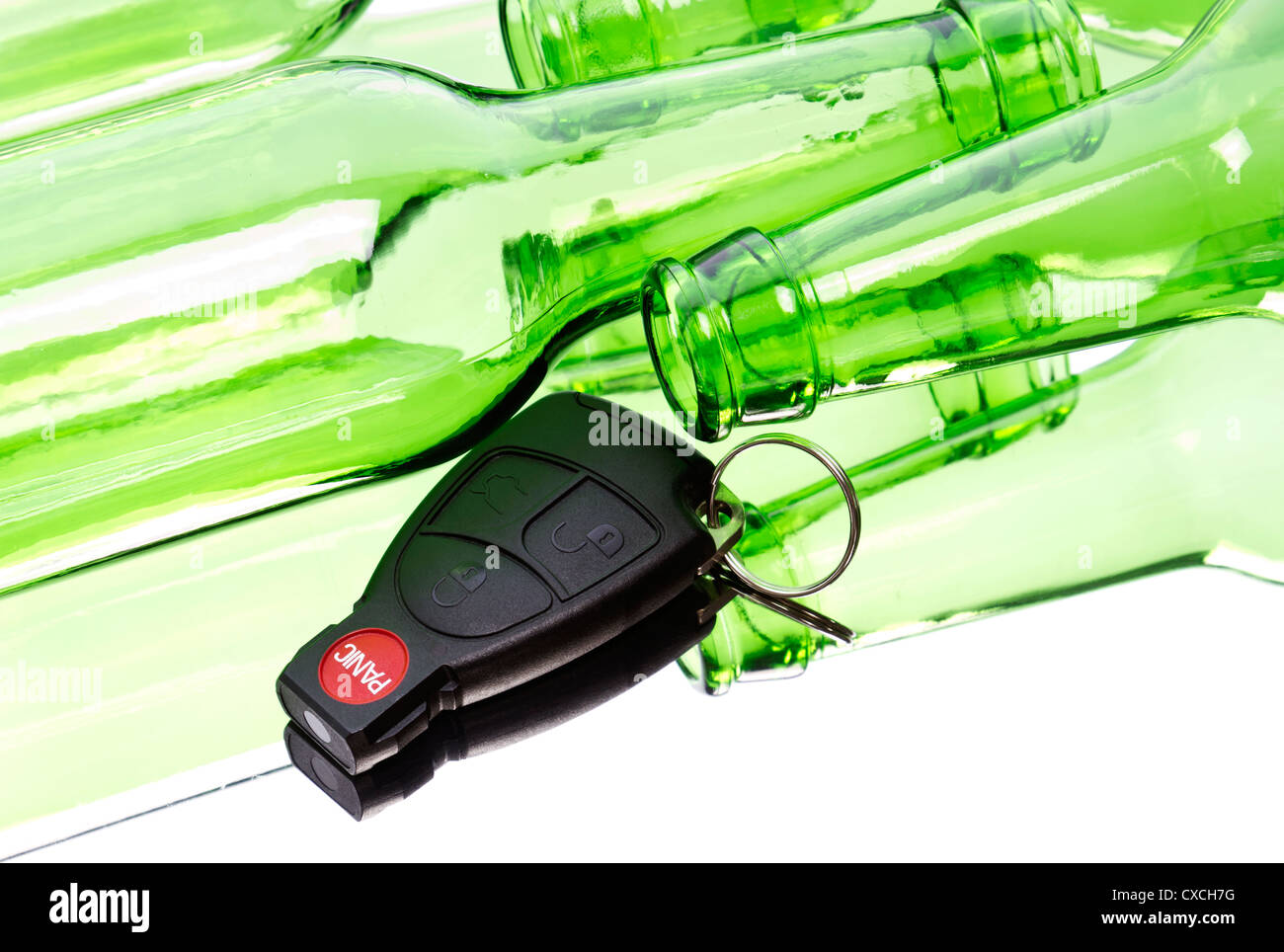 Car key and bunch of empty glass beer bottles to illustrate drunk driving concept. Stock Photo