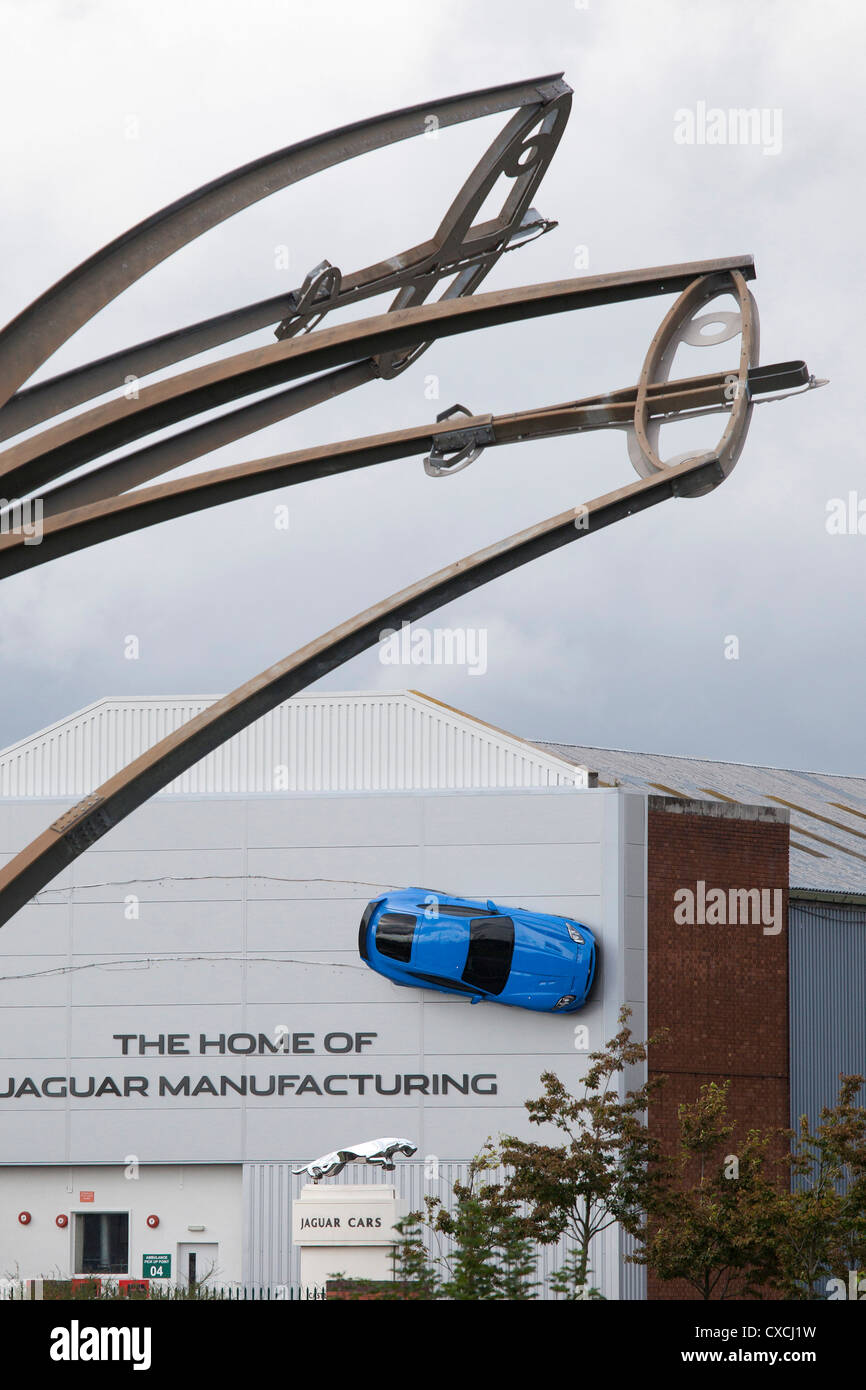 A Jaguar car is attached forty feet in the air to the outside wall of