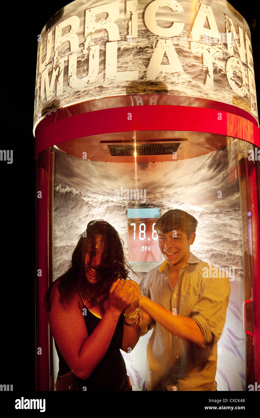 A young couple experiencing high winds in the Hurricane Simulator machine, London Aquarium, London UK Stock Photo