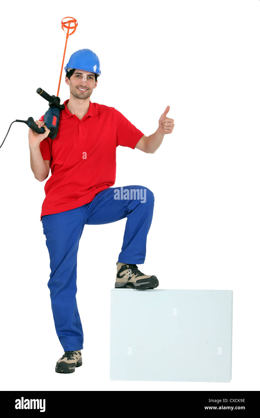 Man holding paint mixer Stock Photo Alamy