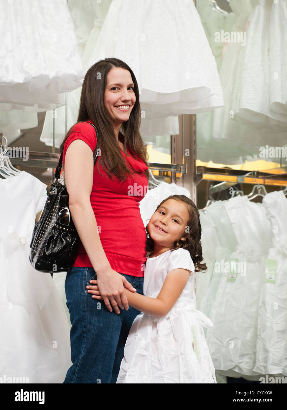 Mixed race mother and daughter in dress store Stock Photo Alamy