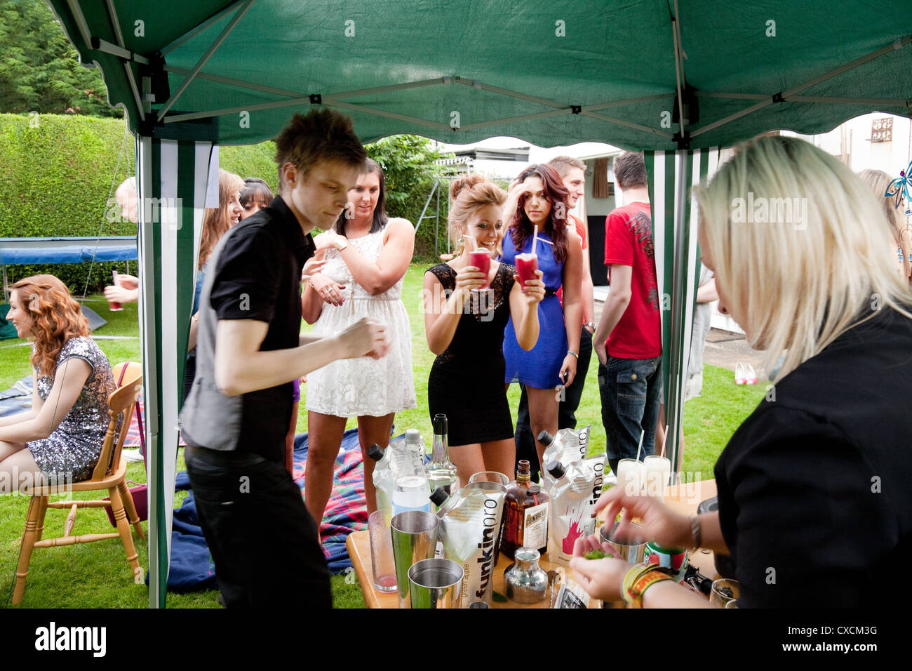 UK teenagers drinking alcohol cocktails at a party, England UK Stock Photo