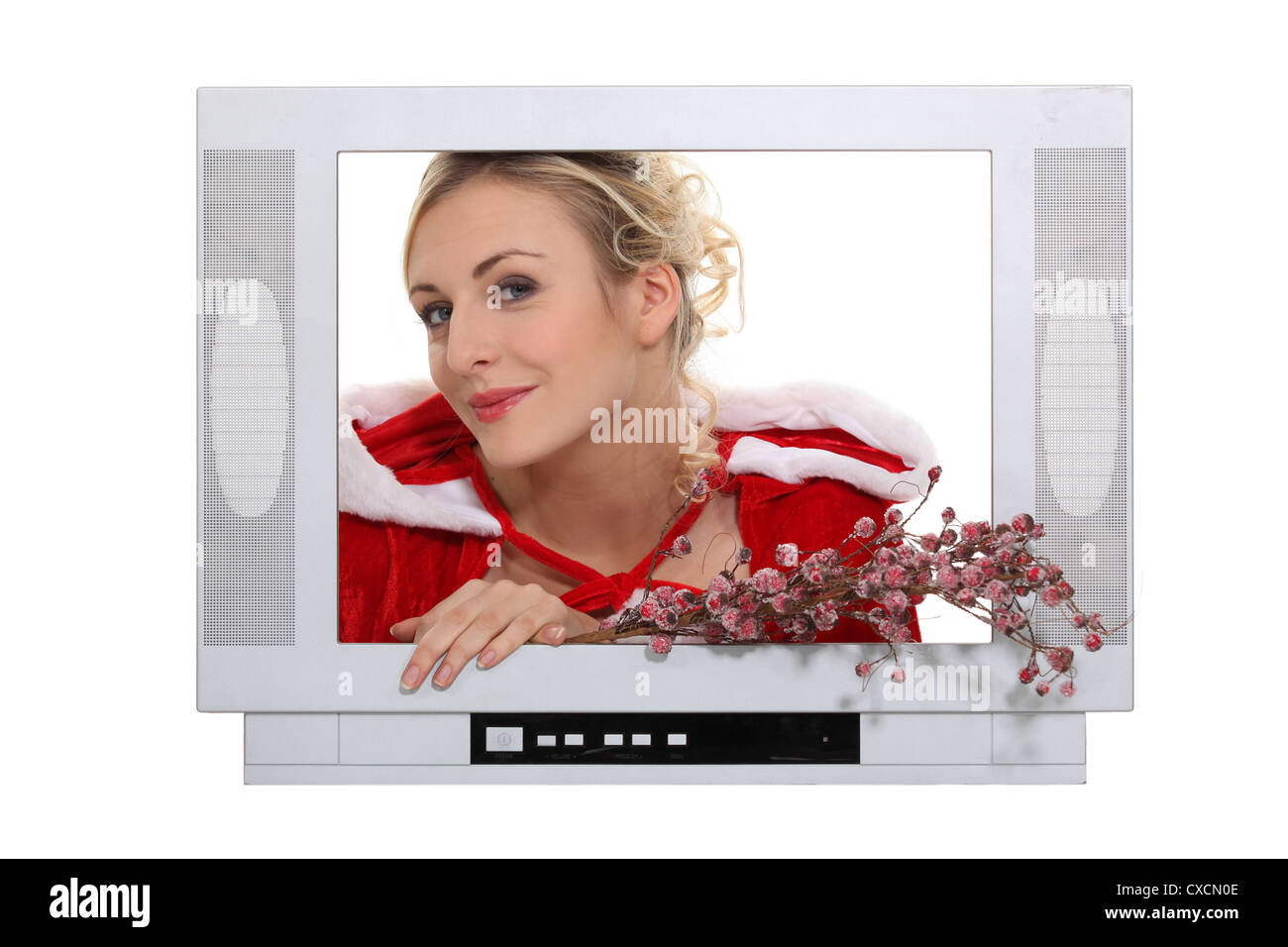 Woman dressed in festive outfit coming out of television Stock Photo