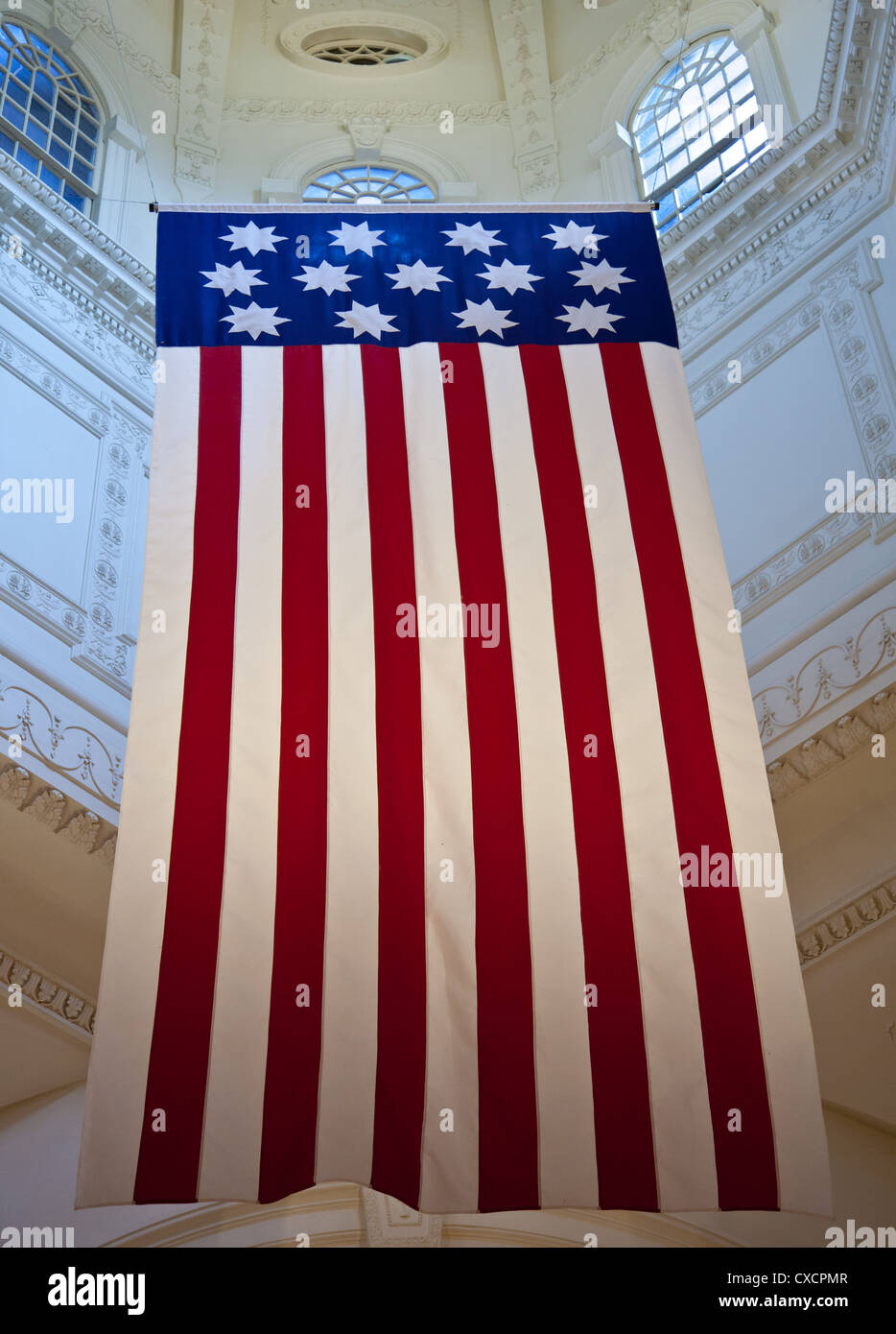 An old flag with the 13 original colonies hangs from the dome of the Maryland State Capital. Stock Photo
