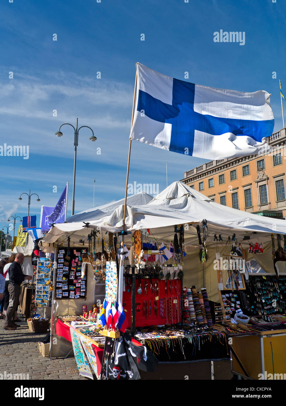Helsinki harbour market stalls with national flag flying in foreground Helsinki Finland Stock Photo