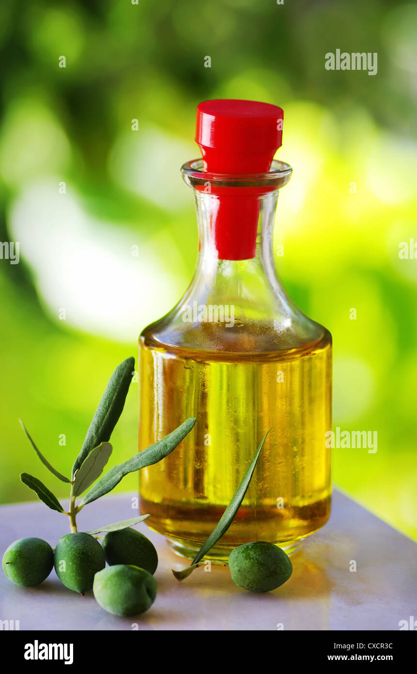 Green olives and olive oil Stock Photo - Alamy