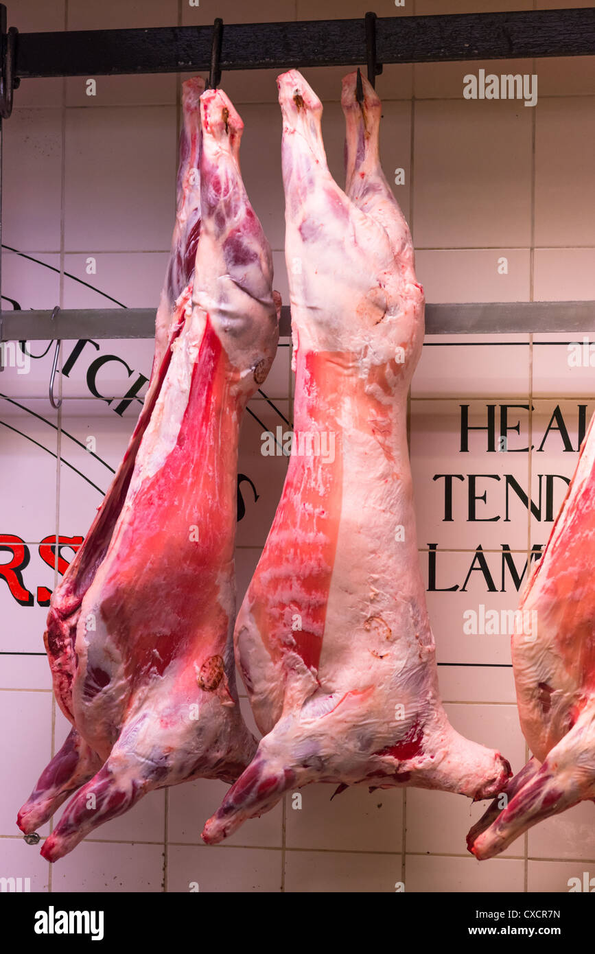 Whole lambs hanging at butchers shop in the English Market, Cork City, Republic of Ireland. Stock Photo