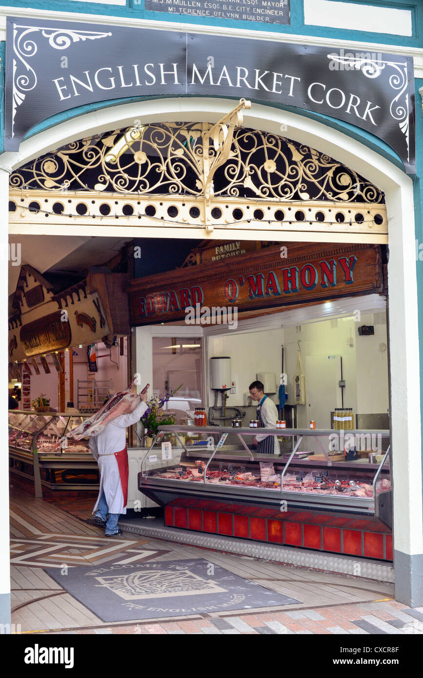 A butcher with a whole over his shoulder at the English Market, Cork
