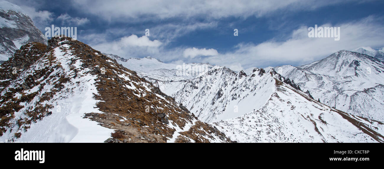 Looking along the ridge of a mountain with snowcapped mountains in the distance, Langtang Valley, Nepal Stock Photo