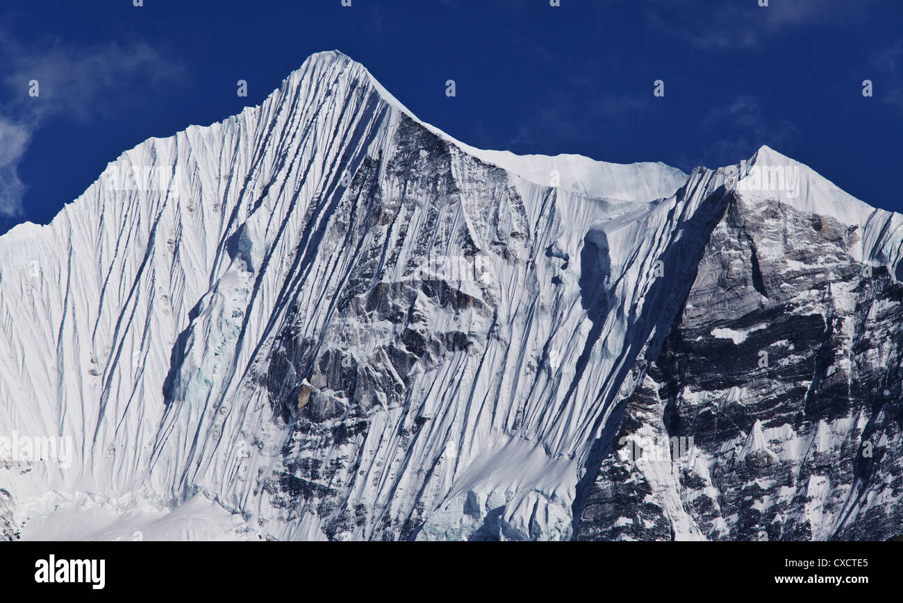 Snowcapped mountain covered with snow and ice along the Langtang Valley, Nepal Stock Photo