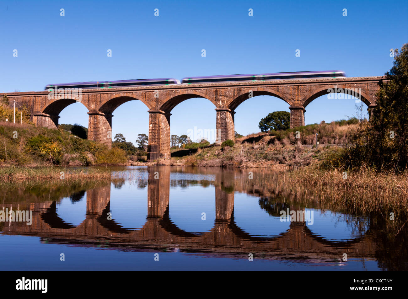 A train crossing the historic Malmsbury Railway Viaduct constructed from blue stone in 1861. Stock Photo