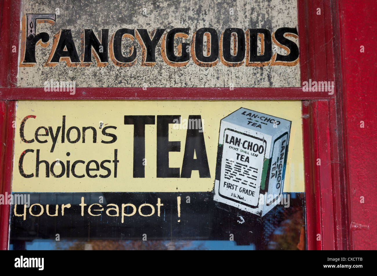 An old shop window advertisement for fancy goods and Ceylon tea. Stock Photo