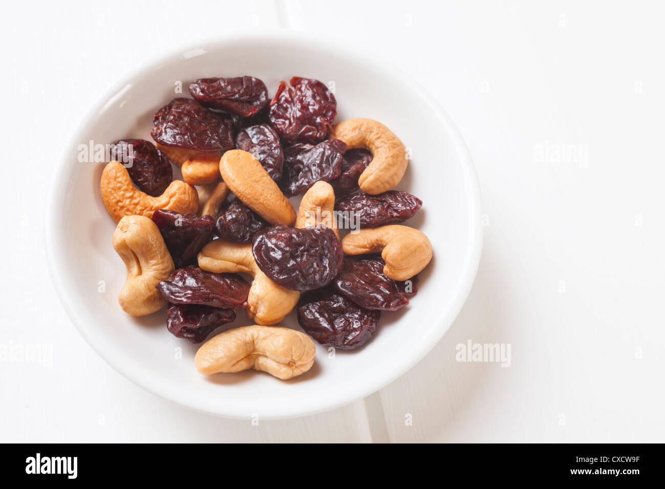 Very small meal or snack of dried cherries and cashew nuts. Stock Photo