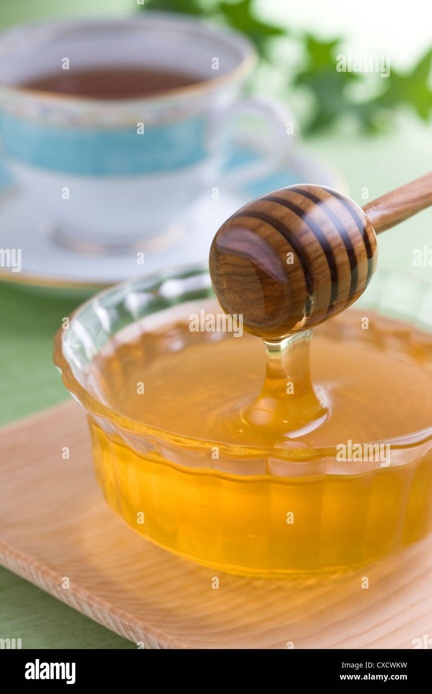Dipping Honey with Honey Dipper Stock Photo Alamy