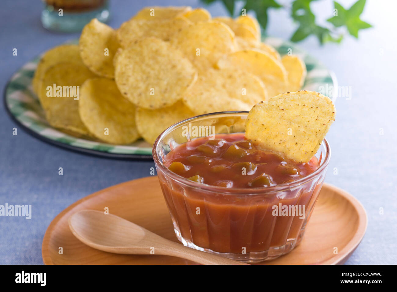 Dipping Corn Chips into Salsa Stock Photo