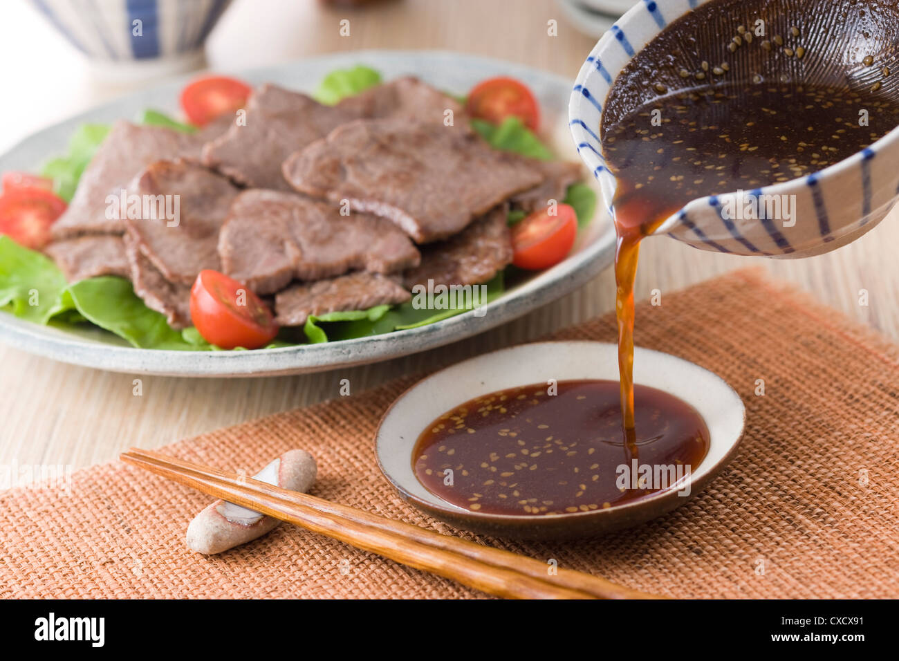 Pouring Korean Barbeque Sauce into Plate Stock Photo