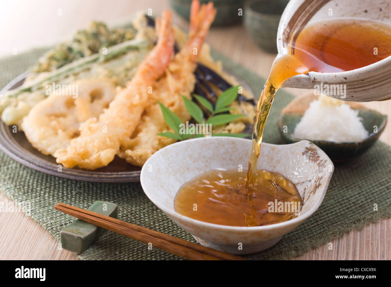 Pouring Tempura Dipping Sauce into Plate Stock Photo