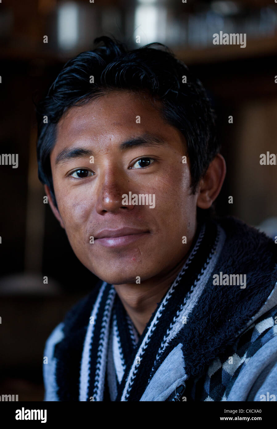 Portrait of a young Nepali man smiling, Nepal Stock Photo