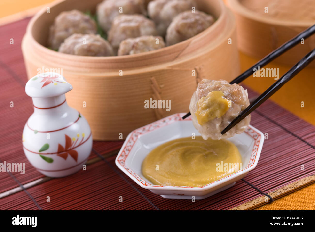 Putting Chinese Hot Mustard on Shaomai Stock Photo Alamy