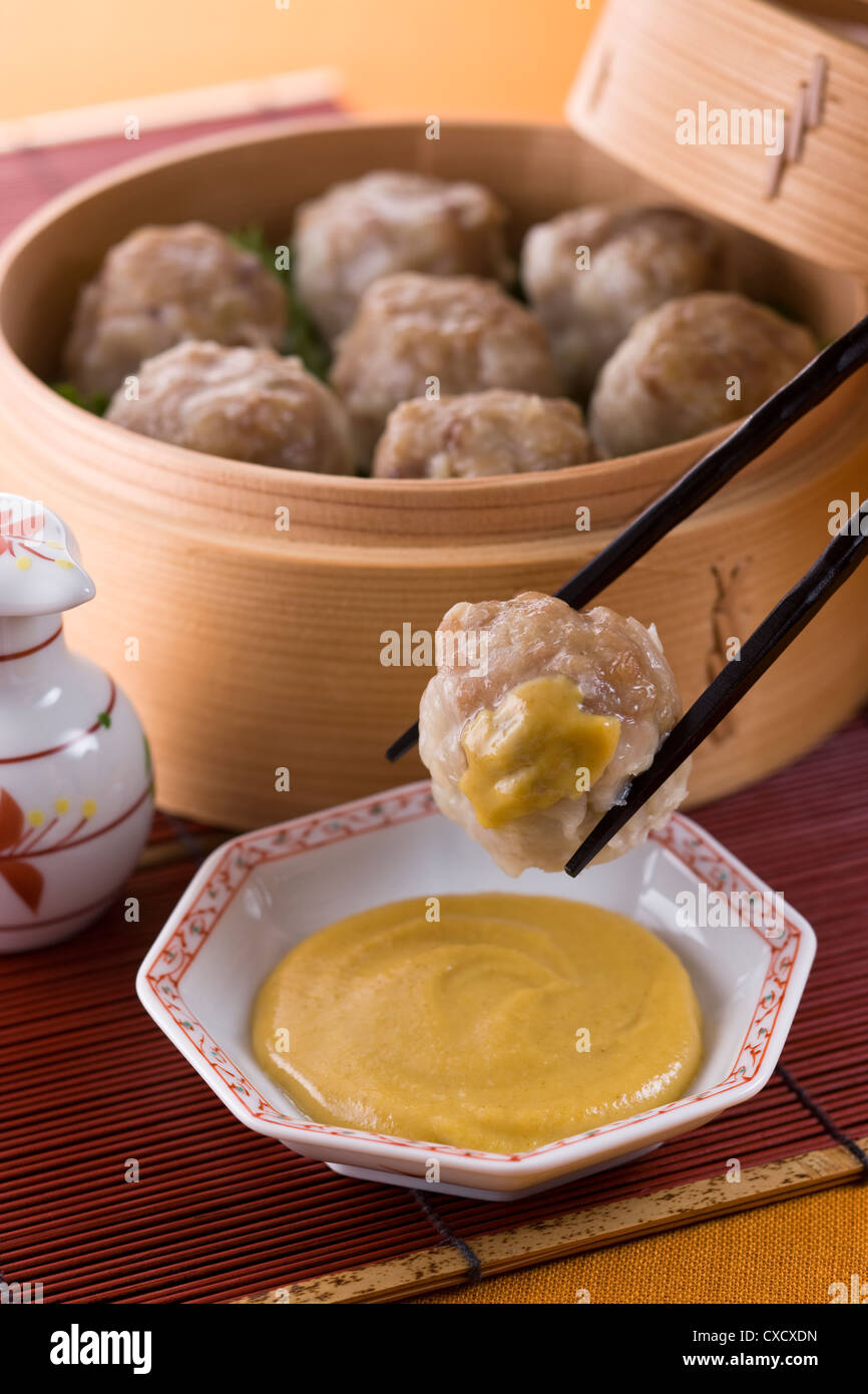 Putting Chinese Hot Mustard on Shaomai Stock Photo Alamy