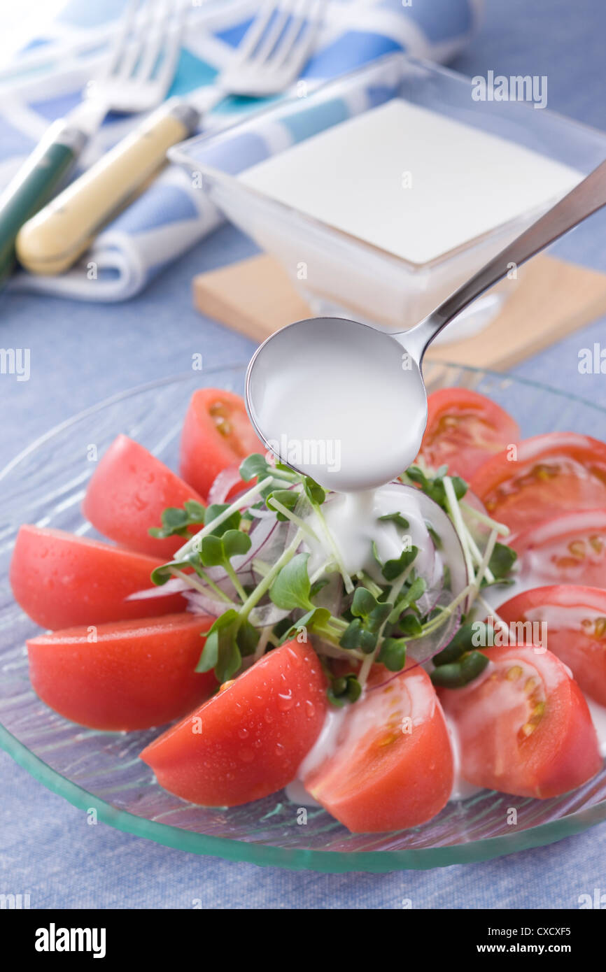 Pouring French Dressing on Tomato Salad Stock Photo Alamy