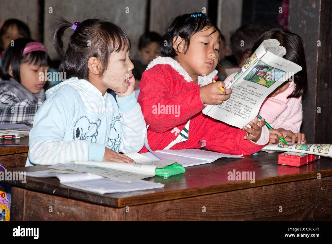 Myanmar, Burma, Kalaw. Elementary School Classroom and Burmese Children. Girls Reading. Stock Photo