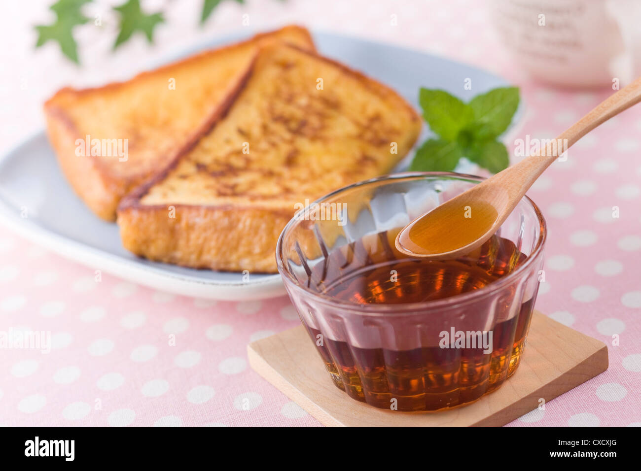 Scooping Maple Syrup with Spoon Stock Photo