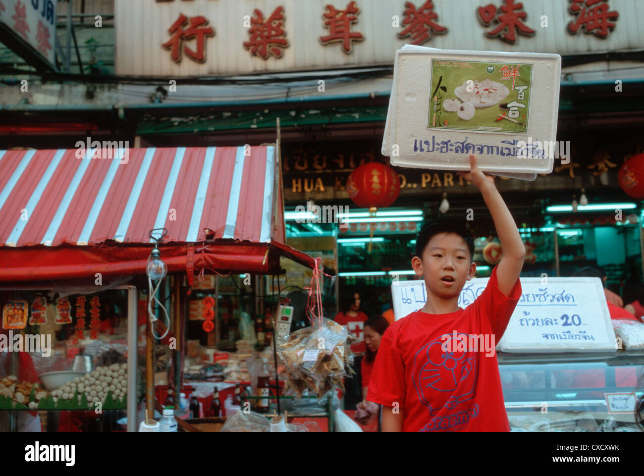Bangkok, Asian boy is doing advertising for a food stall Stock Photo