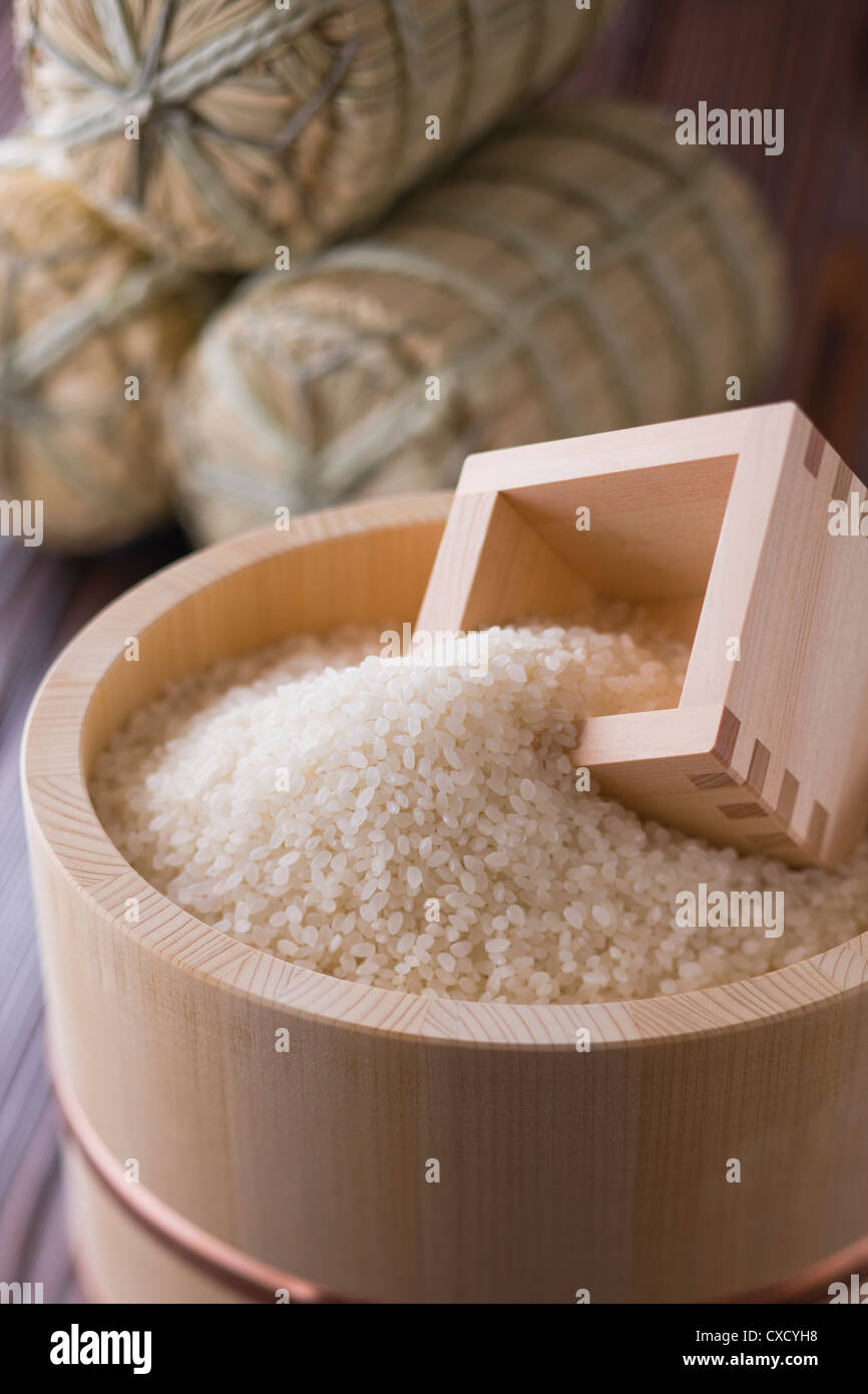 Rice and Measuring Cup in Wooden Tub Stock Photo - Alamy