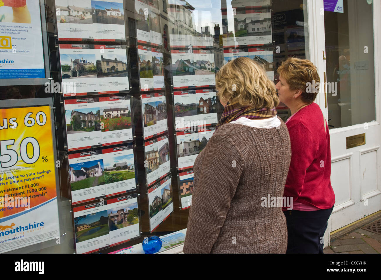 People looking in estate agents window in Abergavenny Gwent South Wales UK Stock Photo