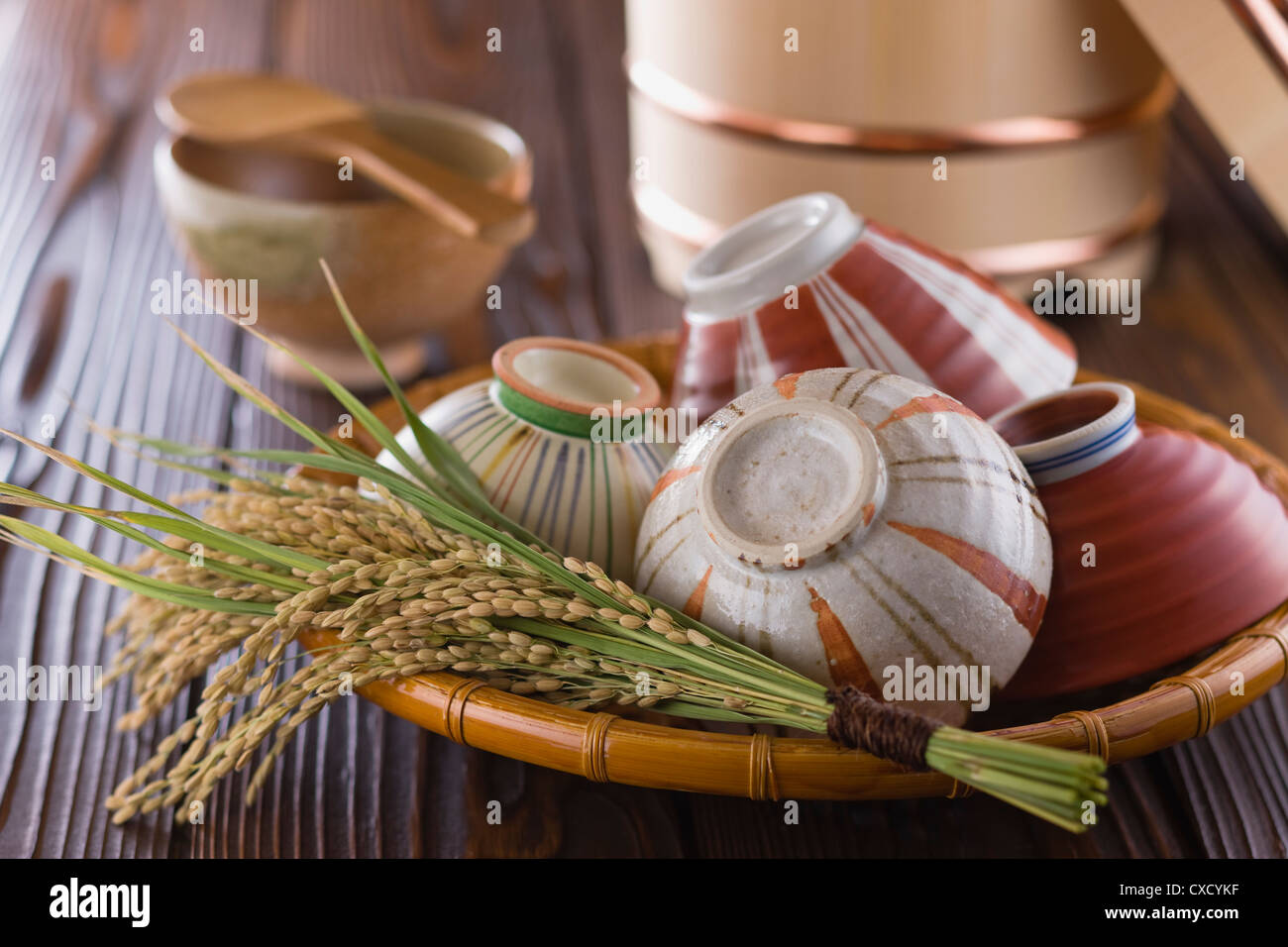 Rice Ear and Rice Bowls in Basket Stock Photo