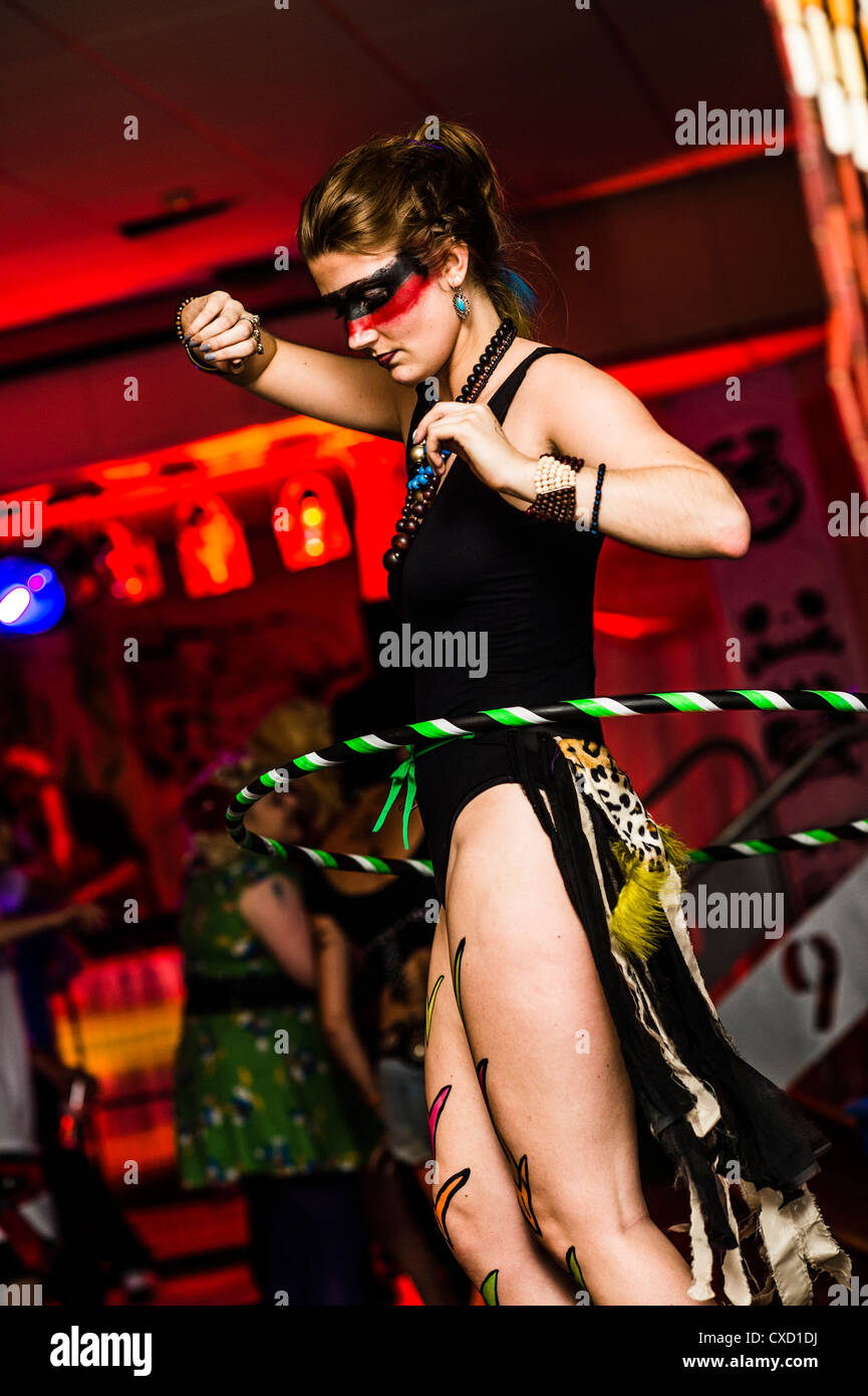 A young woman dancing with a hula hoop at a neon / voodoo / tribal themed  rave dance party night in a club, UK Stock Photo - Alamy