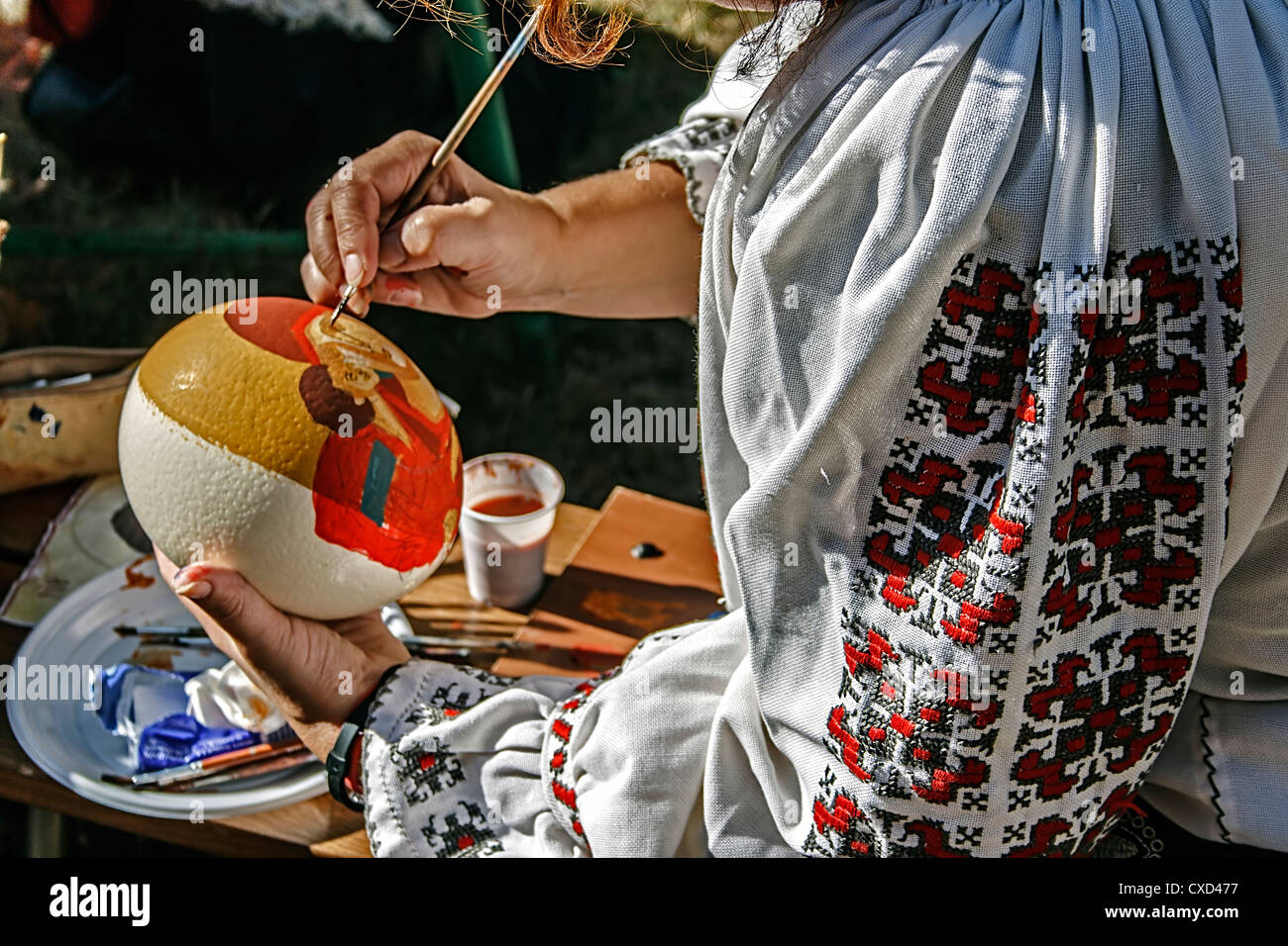 Costrum woman dressed in traditional Romanian and ostrich egg painting Stock Photo
