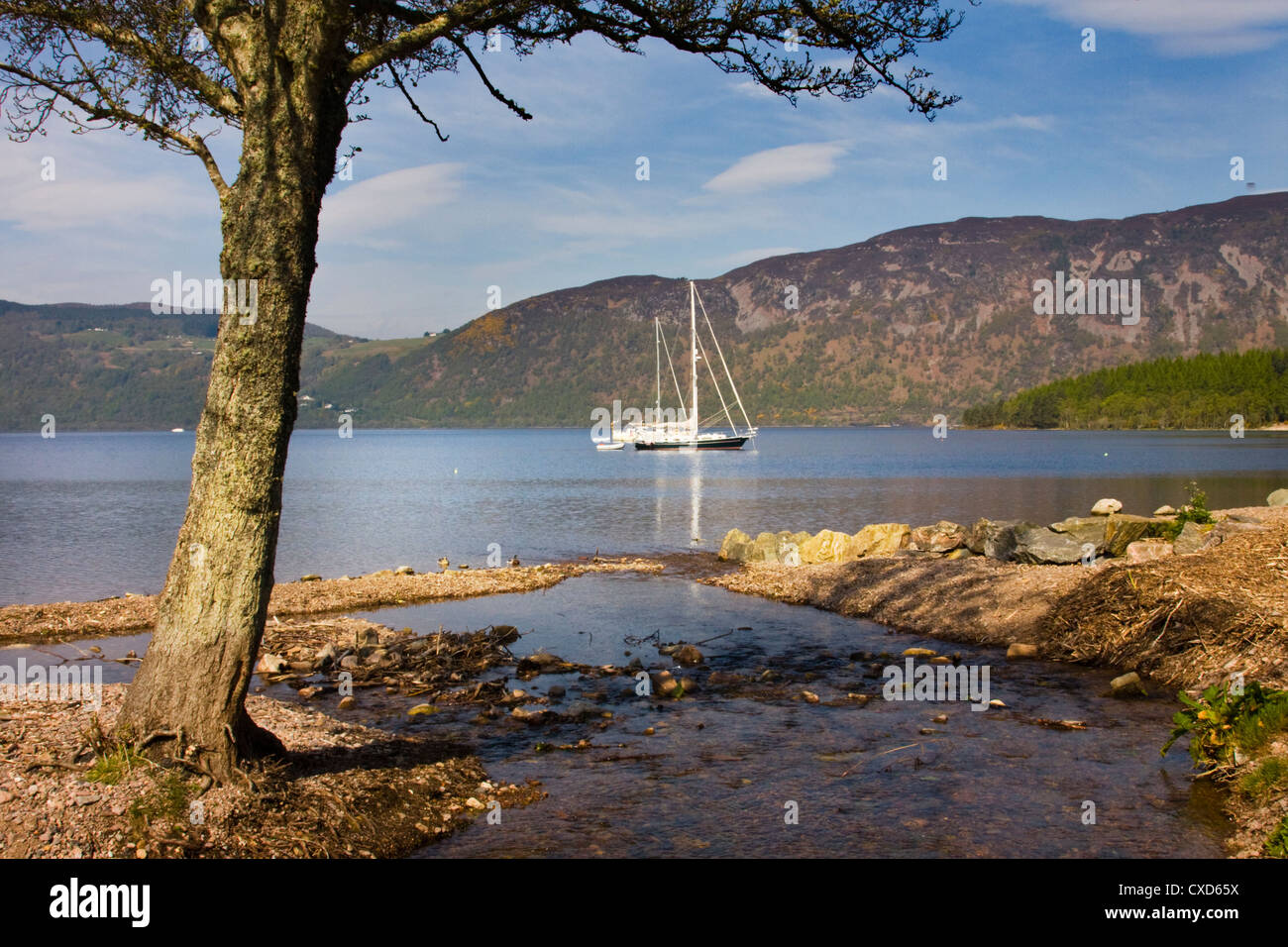 Yachts anchored on Loch Ness near to The Dores Inn and Dores Village. Stock Photo