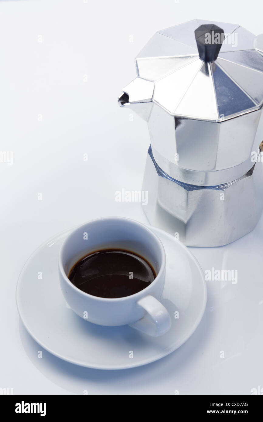 studio still life of italian style expresso maker with expresso cup and saucer Stock Photo